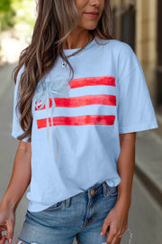 Sky blue All-American Chic crewneck tee with flag bow graphic and relaxed fit