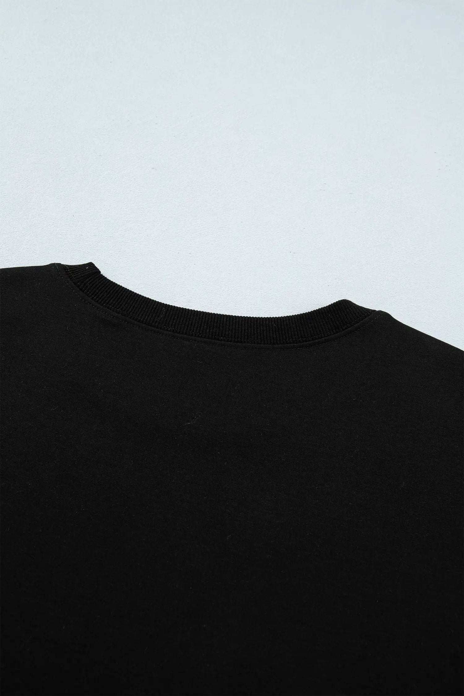 Black short sleeve top with metal buttons for effortless chic mom style