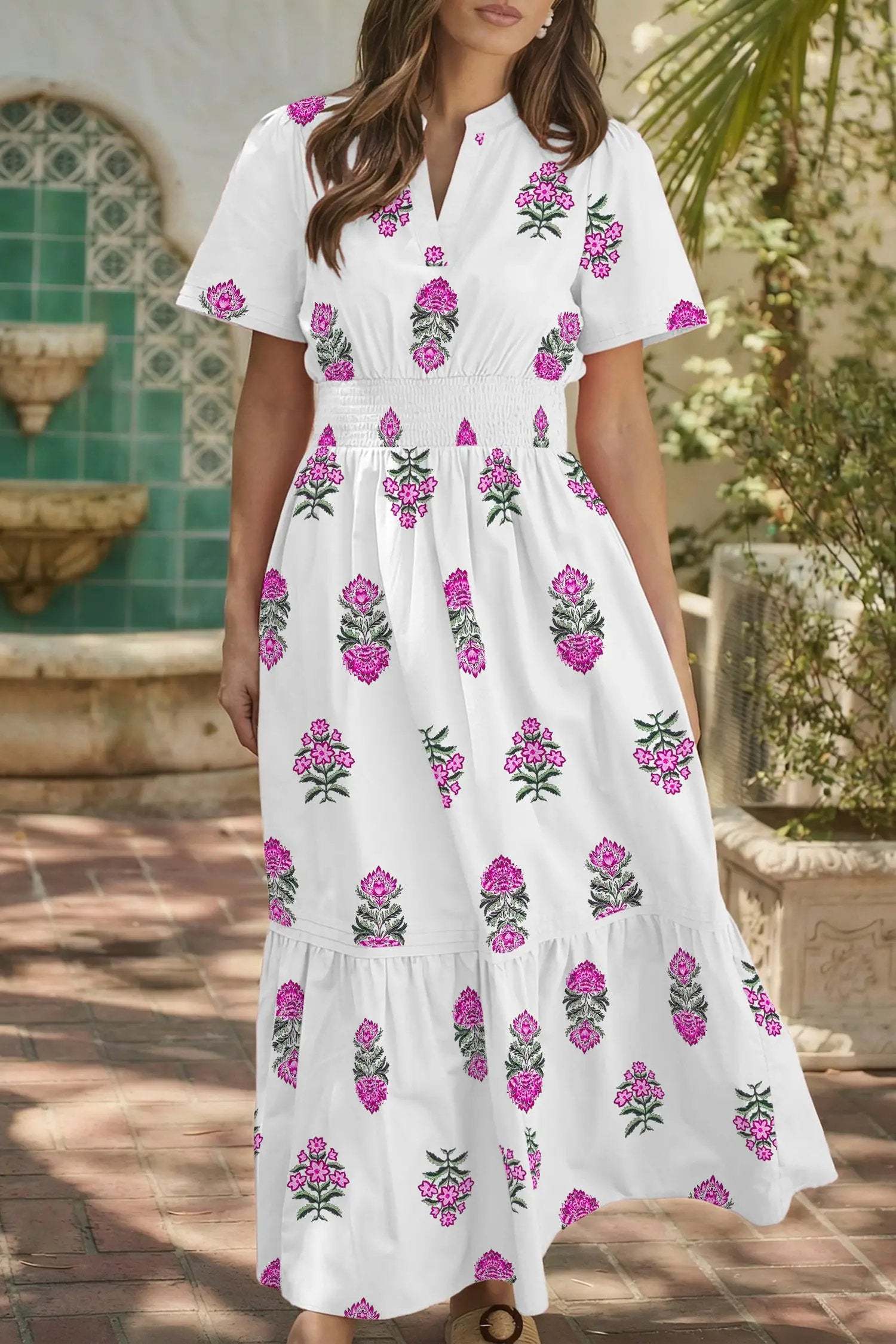 Woman wearing a floral print split neck maxi dress with shirred waist and ruffle hem embodying main character energy