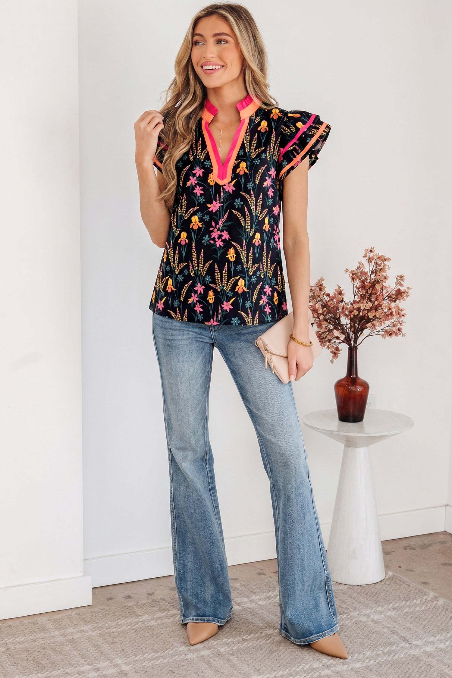 Black floral print tiered blouse with short flutter sleeves and contrast trim neckline