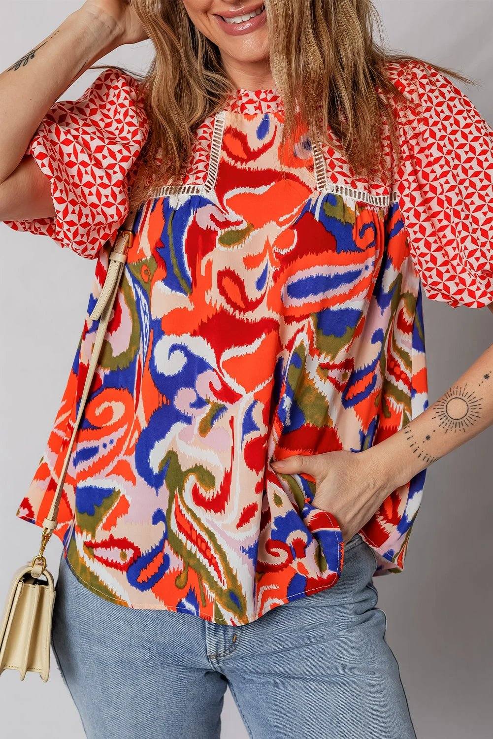 Woman wearing effortless boho chic paisley geometric puff sleeve blouse top