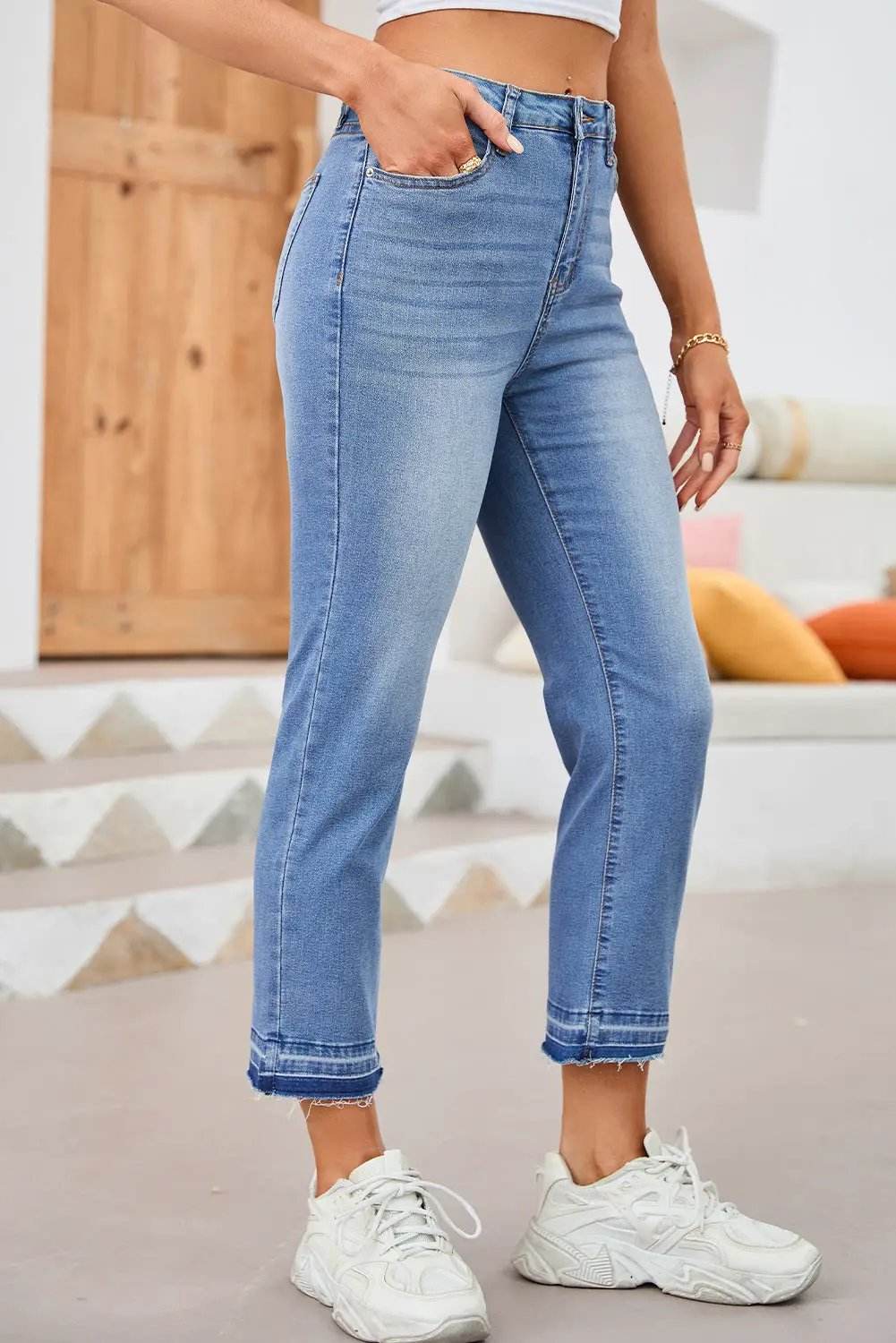 Whiskered wash cropped jeans with raw hem showcasing main character energy style