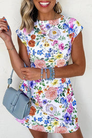 Woman wearing Confidence In Bloom floral print cap sleeve mini dress outdoors