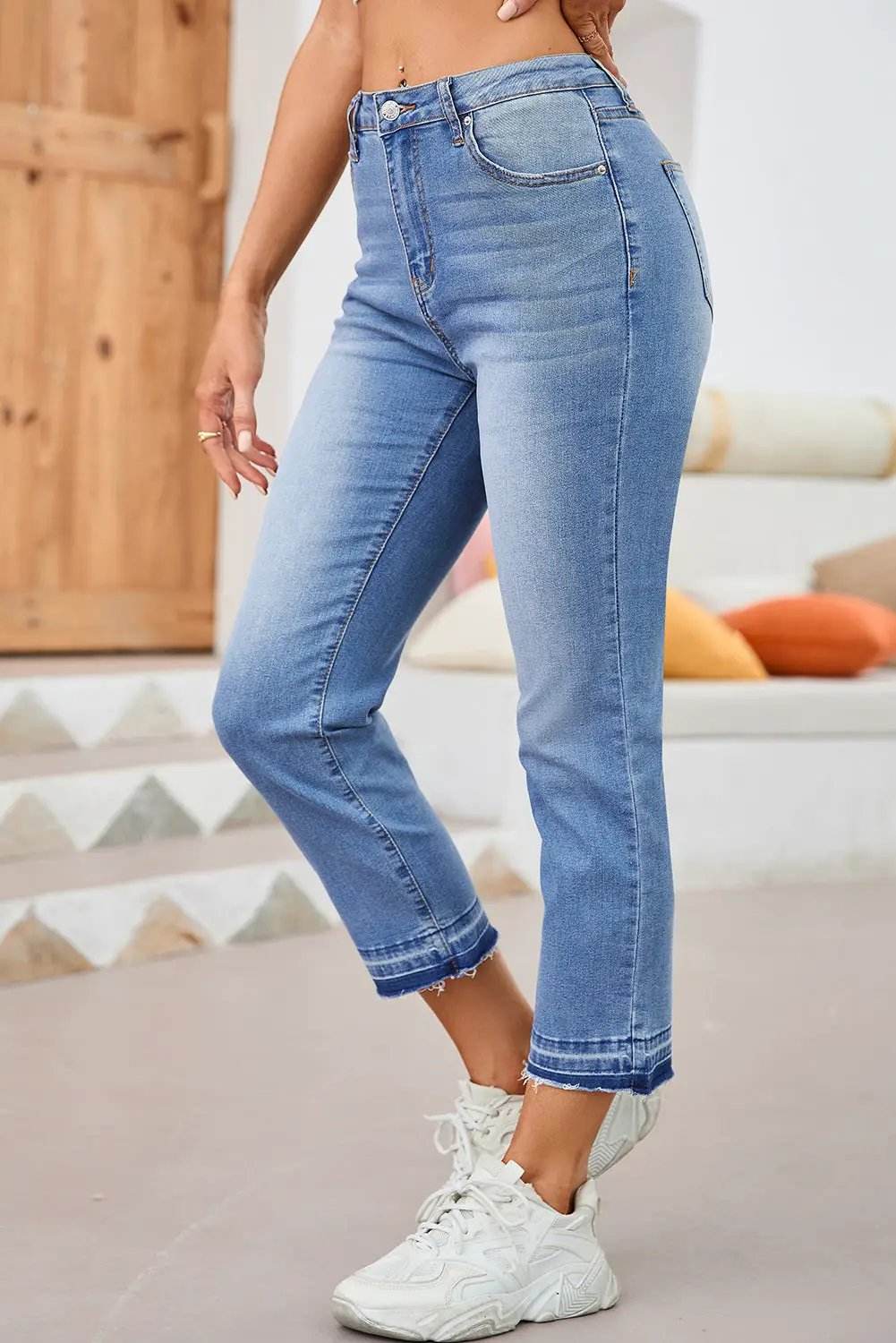 Whiskered wash cropped jeans with raw hem showcasing Main Character Energy style