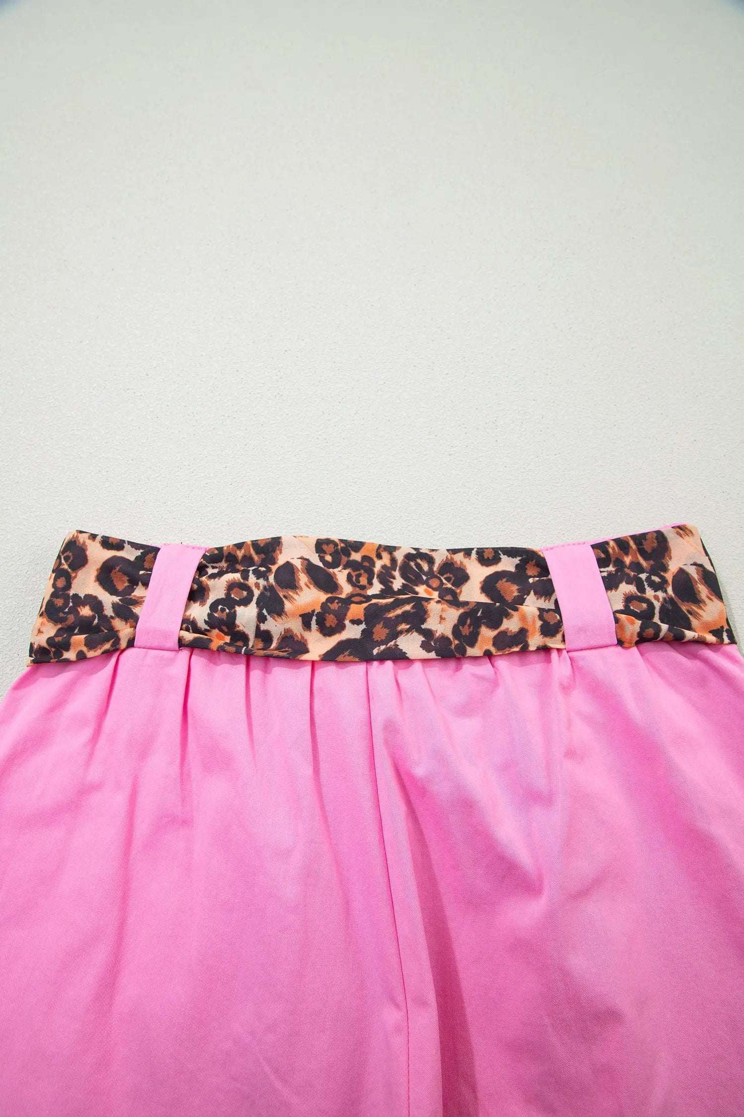 Pink pleated wide-leg shorts with leopard contrast sash belt for weekend vibe style