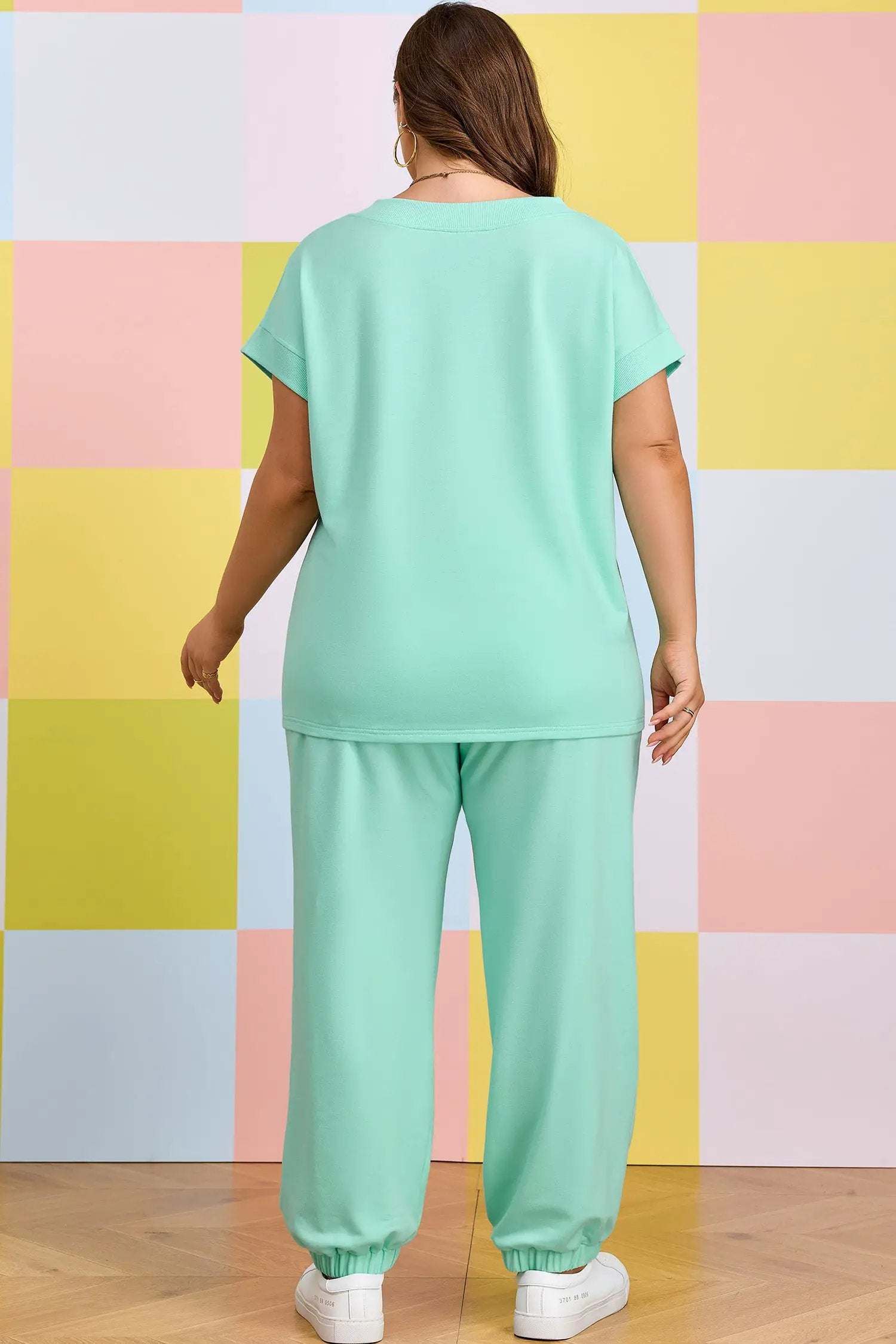 Plus size woman wearing mom vibes V-neck tee and drawstring pants outfit set