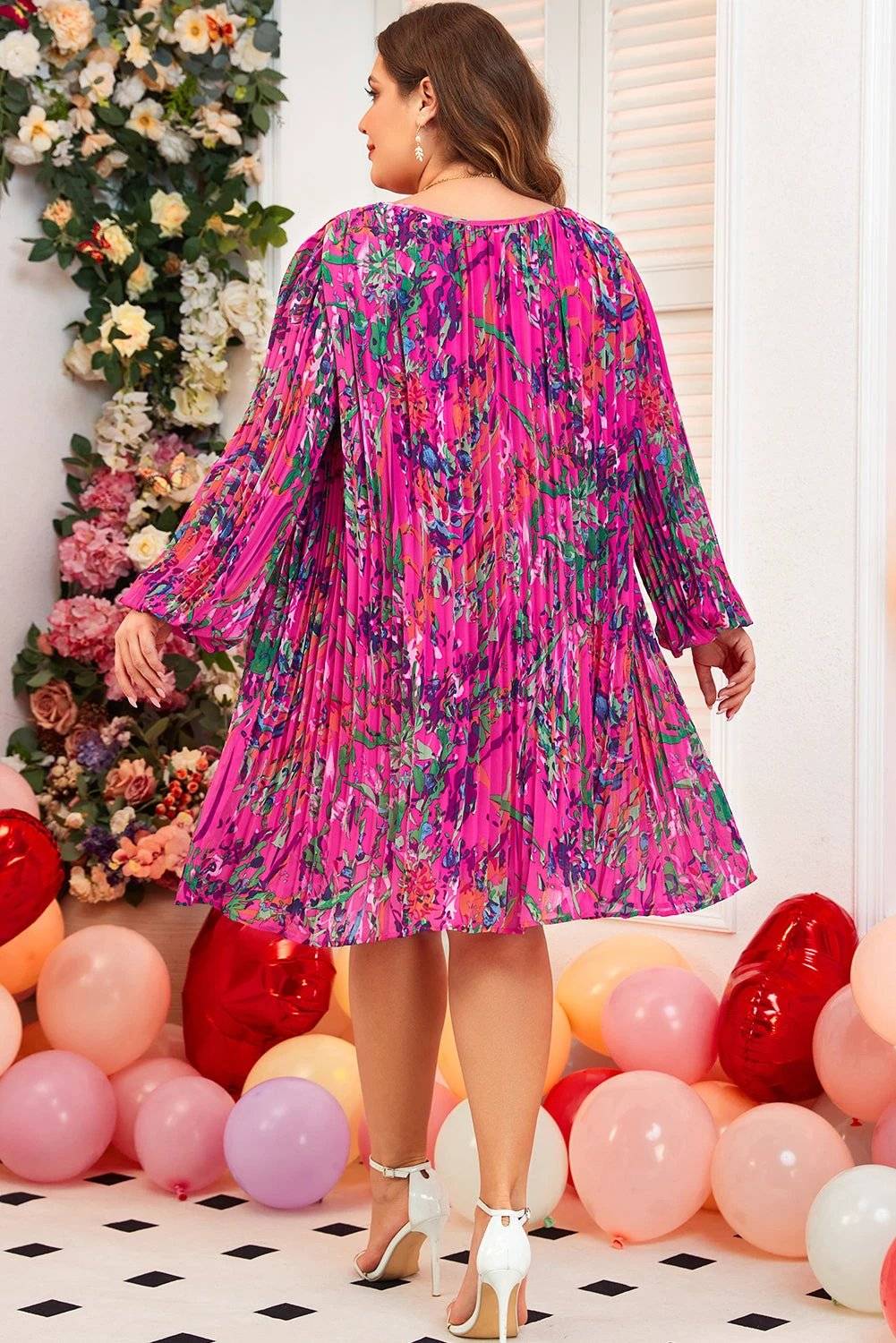 Plus size abstract floral print pleated dress with relaxed A-line silhouette and vibrant colors
