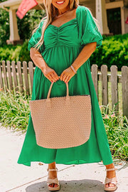 Plus size bright green ruched front maxi dress with puff sleeves and flowy silhouette