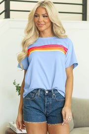 Soft blue tee with rainbow stripe patch front and relaxed fit casual style