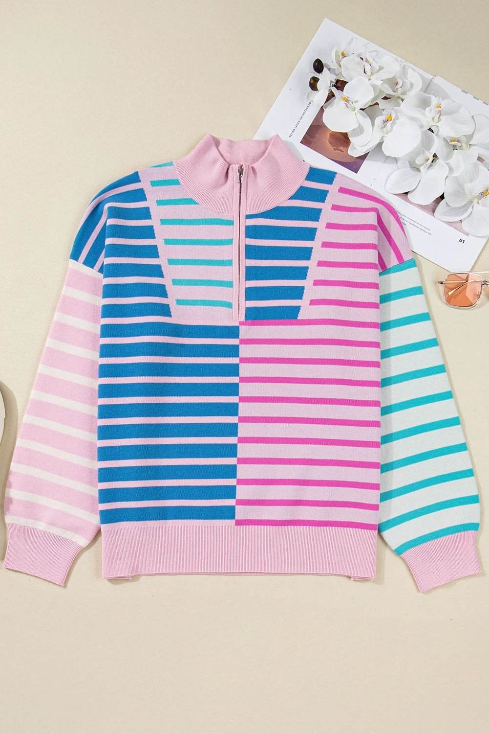 Plus size striped colorblock half zip sweater in pastel pink, blue, and white with relaxed fit and ribbed cuffs