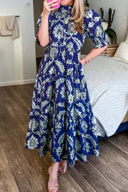 Woman wearing a deep blue floral print frilled collar maxi dress with half sleeves in boho chic style