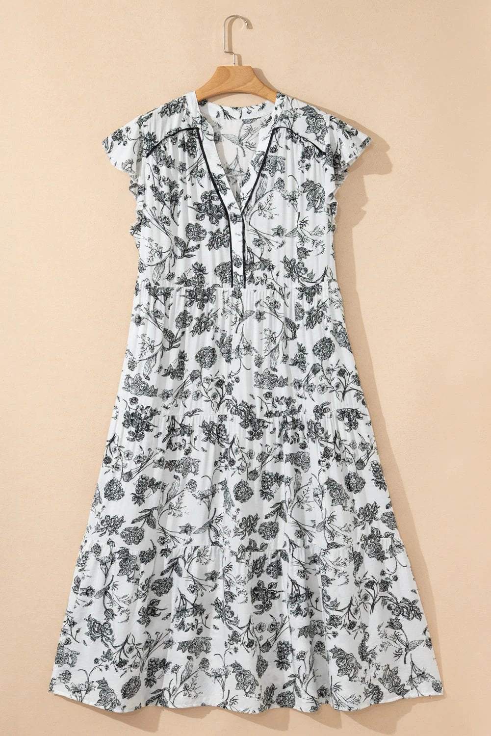 Plus size floral maxi dress with piping trim, notched neck, and ruffle sleeves