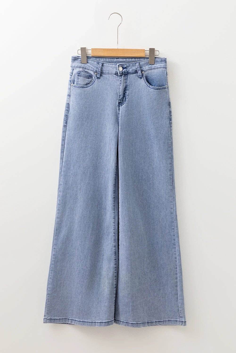 Woman wearing Mom Chic high-waist button-fly wide-leg denim jeans in classic blue wash