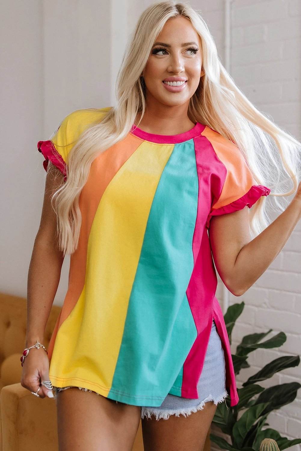 Woman wearing vibrant color block ruffled crew neck relaxed fit t-shirt