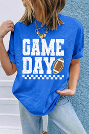 Royal blue crewneck tee with distressed white GAME DAY text, a checkered stripe accent, and a football graphic on the chest