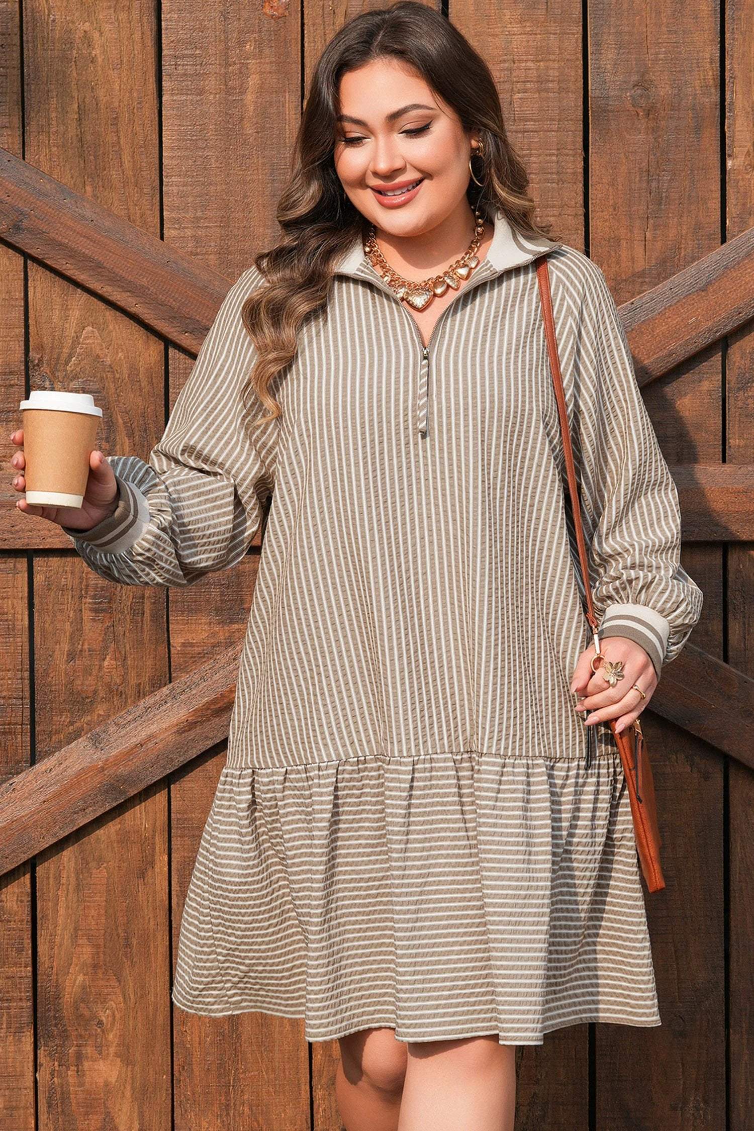 Plus size stripe puff sleeve mini dress with zip-front collar and ruffled hem showcasing main character energy style