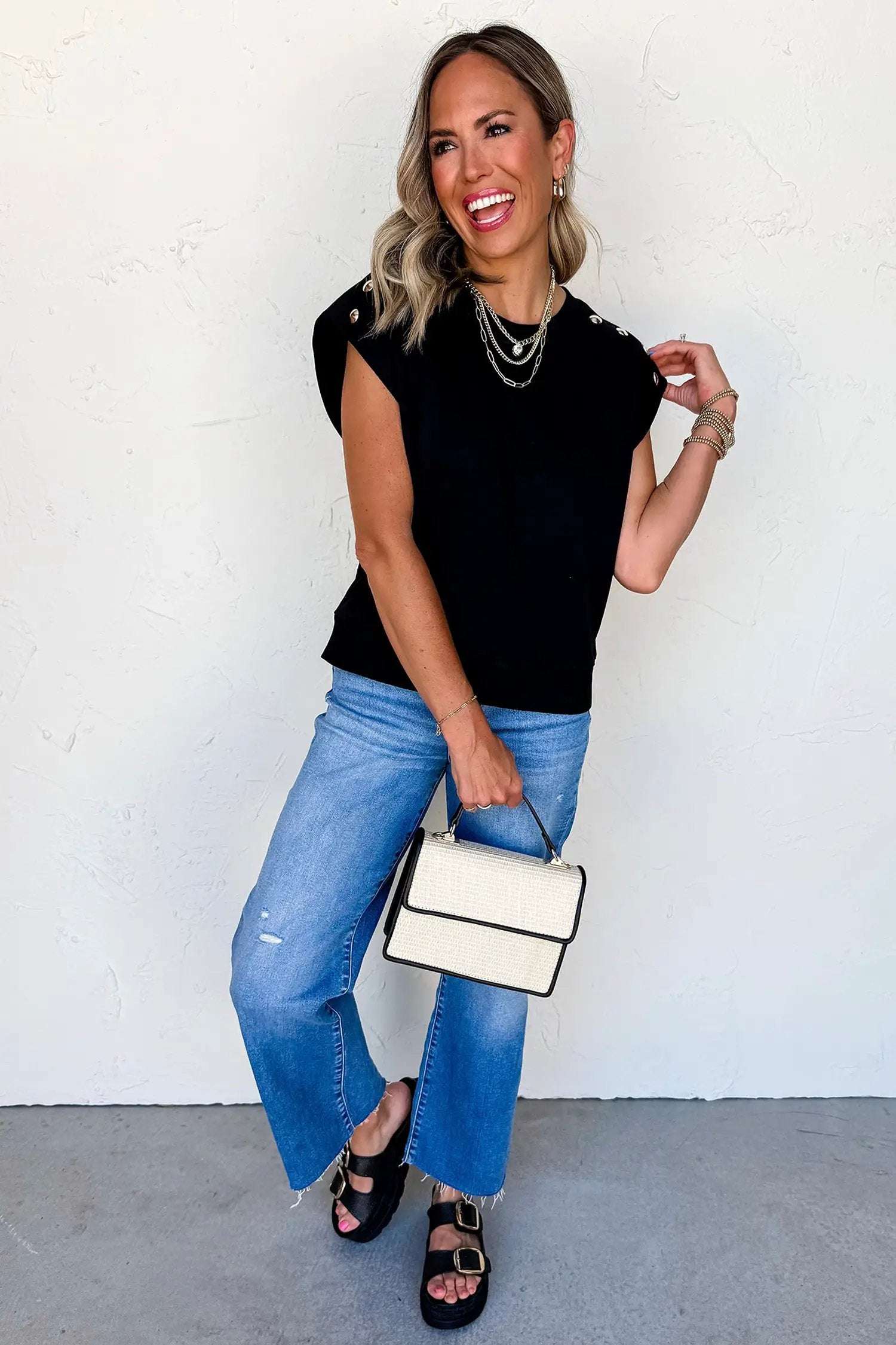Black short sleeve top with metal buttons for effortless chic mom style