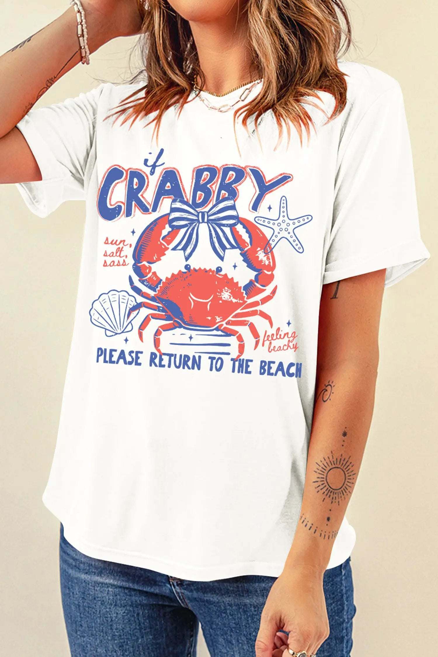 Woman wearing white vacation ready crab graphic tee with coastal beach vibe