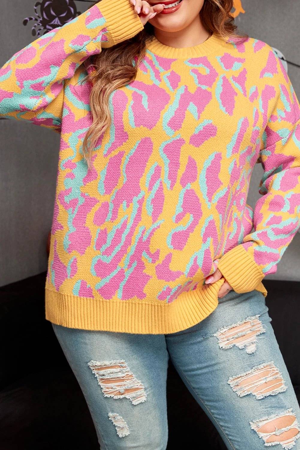 Plus size leopard print sweater with ribbed trim and relaxed fit