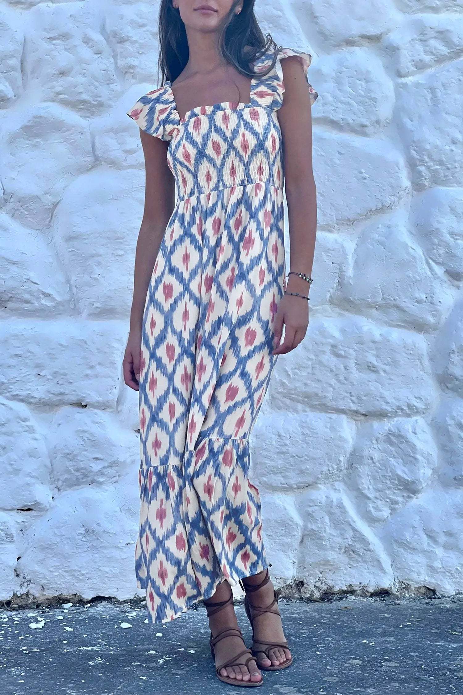 Woman wearing a boho vacation vibes geometric print square neck smocked high waist aline dress with ruffle sleeves