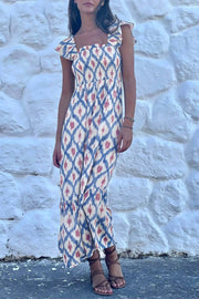 Woman wearing a boho vacation vibes geometric print square neck smocked high waist aline dress with ruffle sleeves