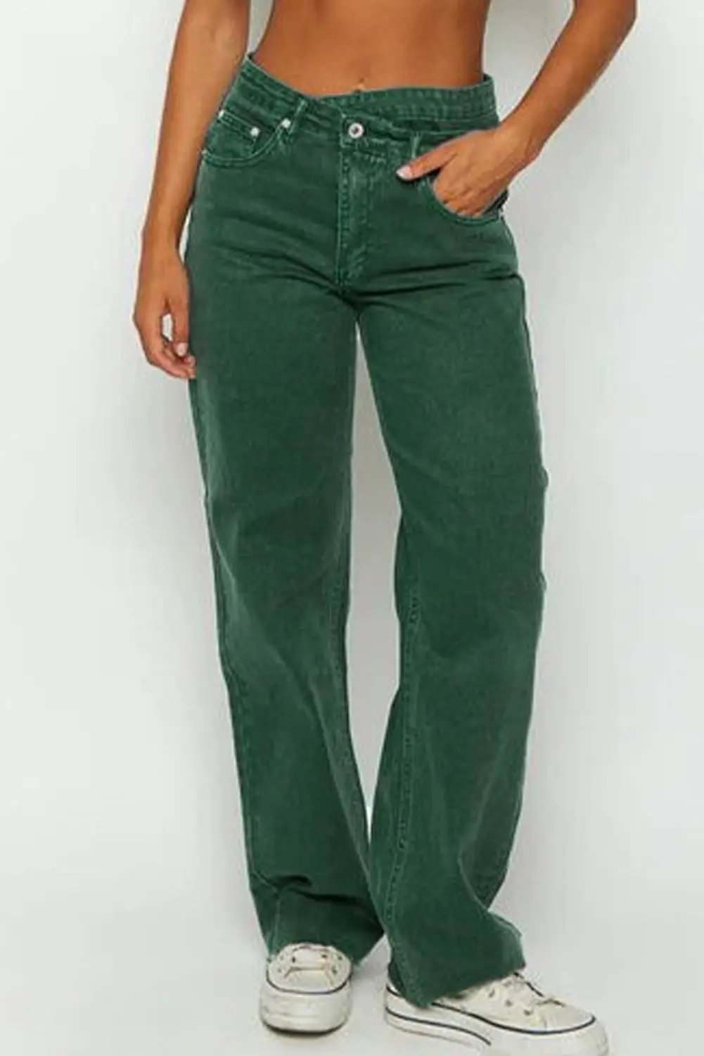 Woman wearing crossed waist raw-hem jeans with a relaxed straight-leg fit and casual western chic style