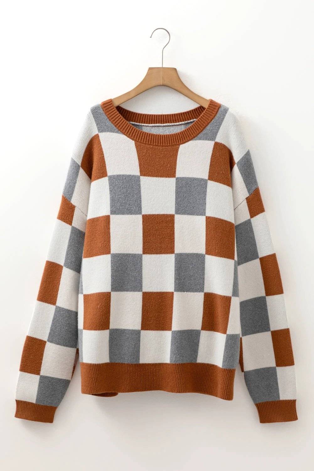 Plus size checkered crewneck sweater with brown, white, and gray pattern and ribbed cuffs and hem