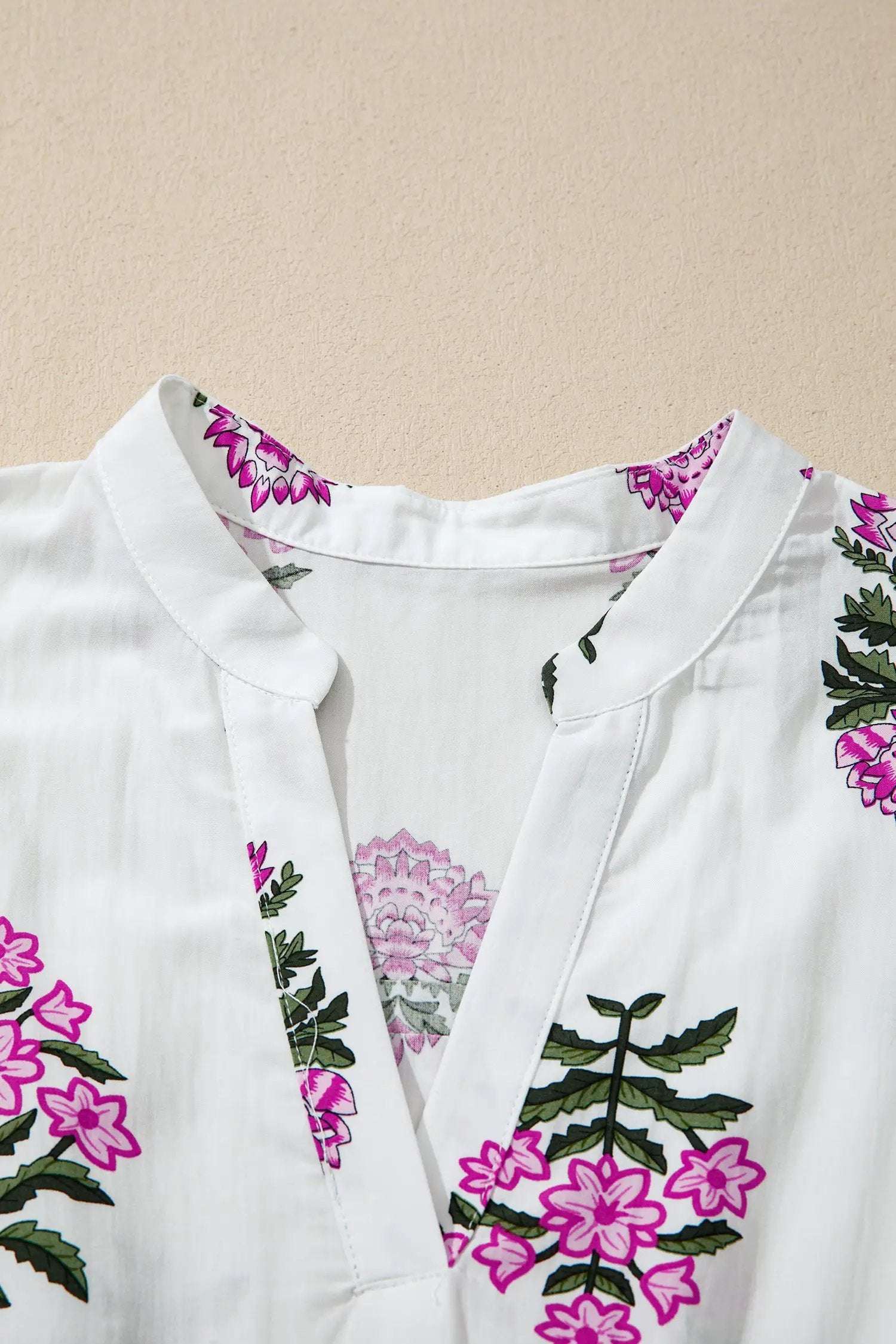 Woman wearing a floral print split neck maxi dress with shirred waist and ruffle hem showcasing main character energy