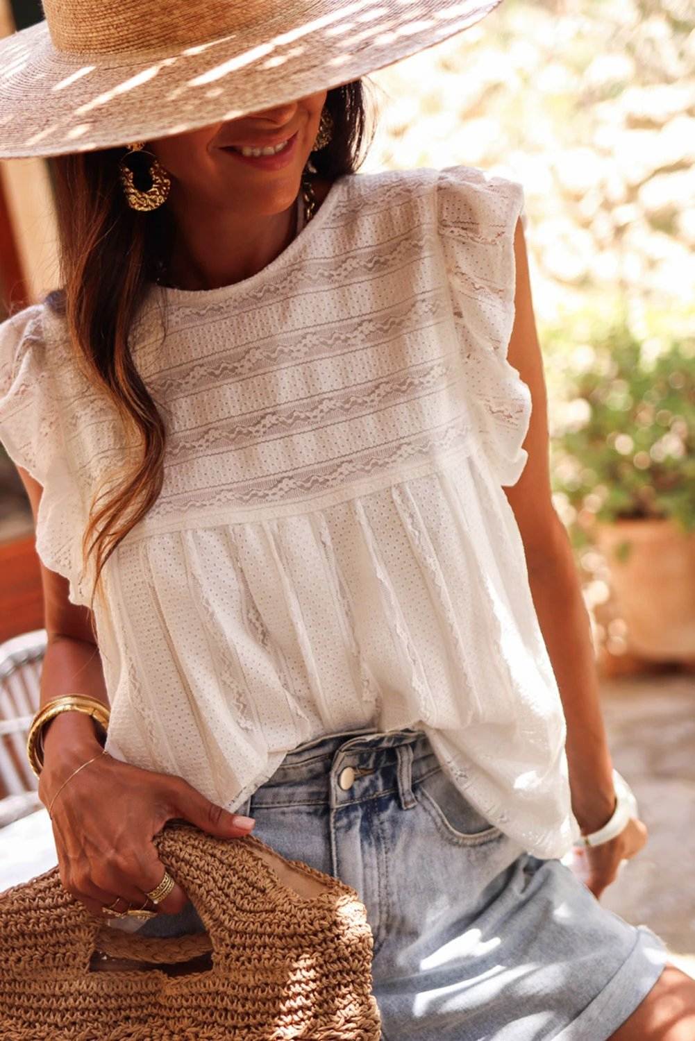 White ruffled lace flowy tank top with boho details on model for casual wear