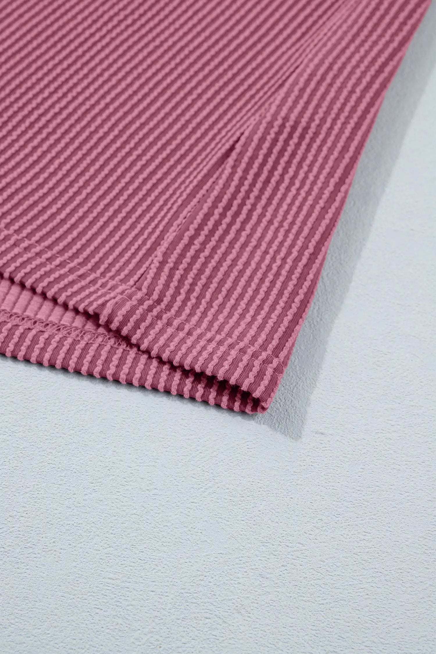Woman wearing soft pink twisted ribbed two-piece set with loose tee and shorts