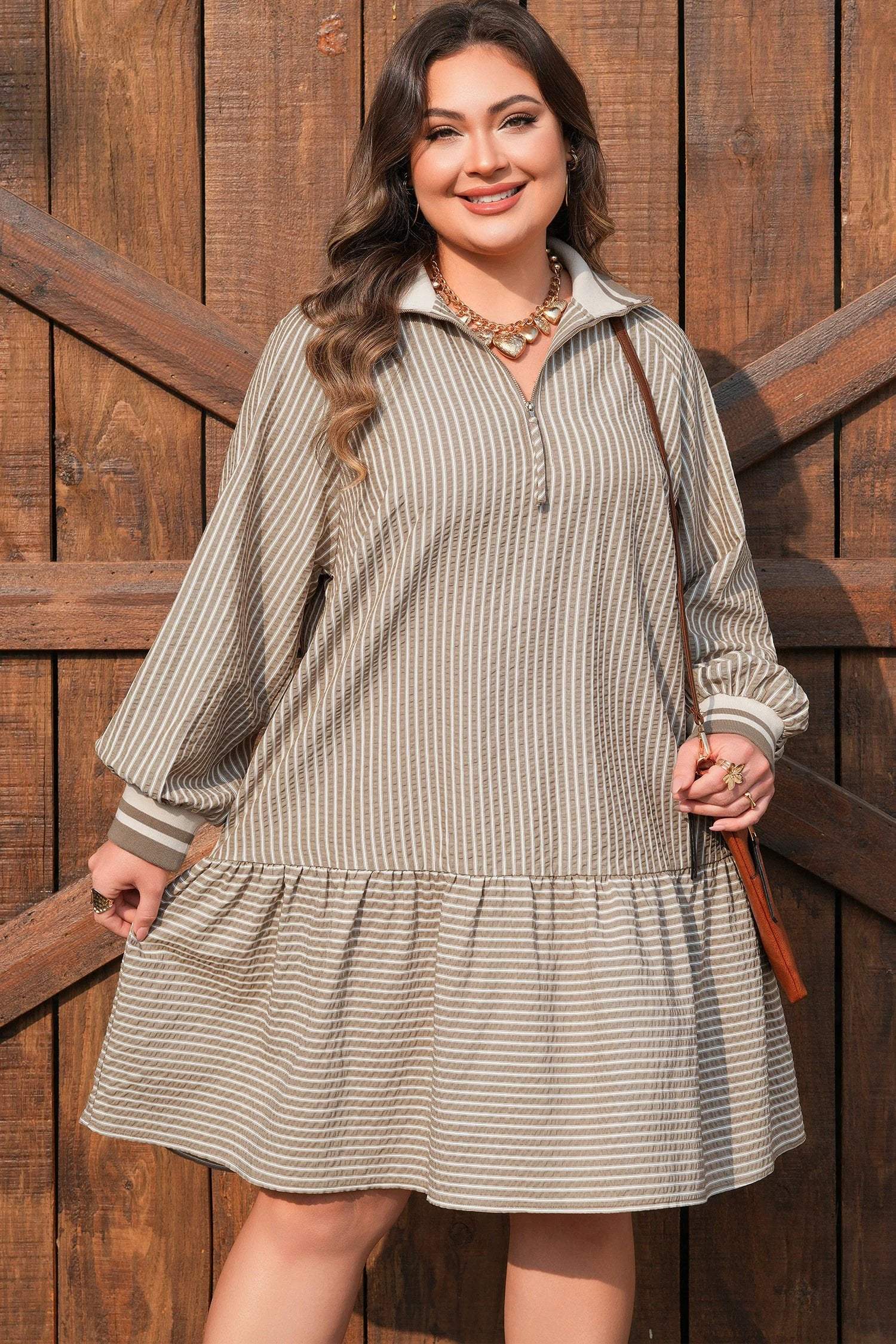 Plus size stripe puff sleeve mini dress with zip-front collar and ruffled hem showcasing main character energy style