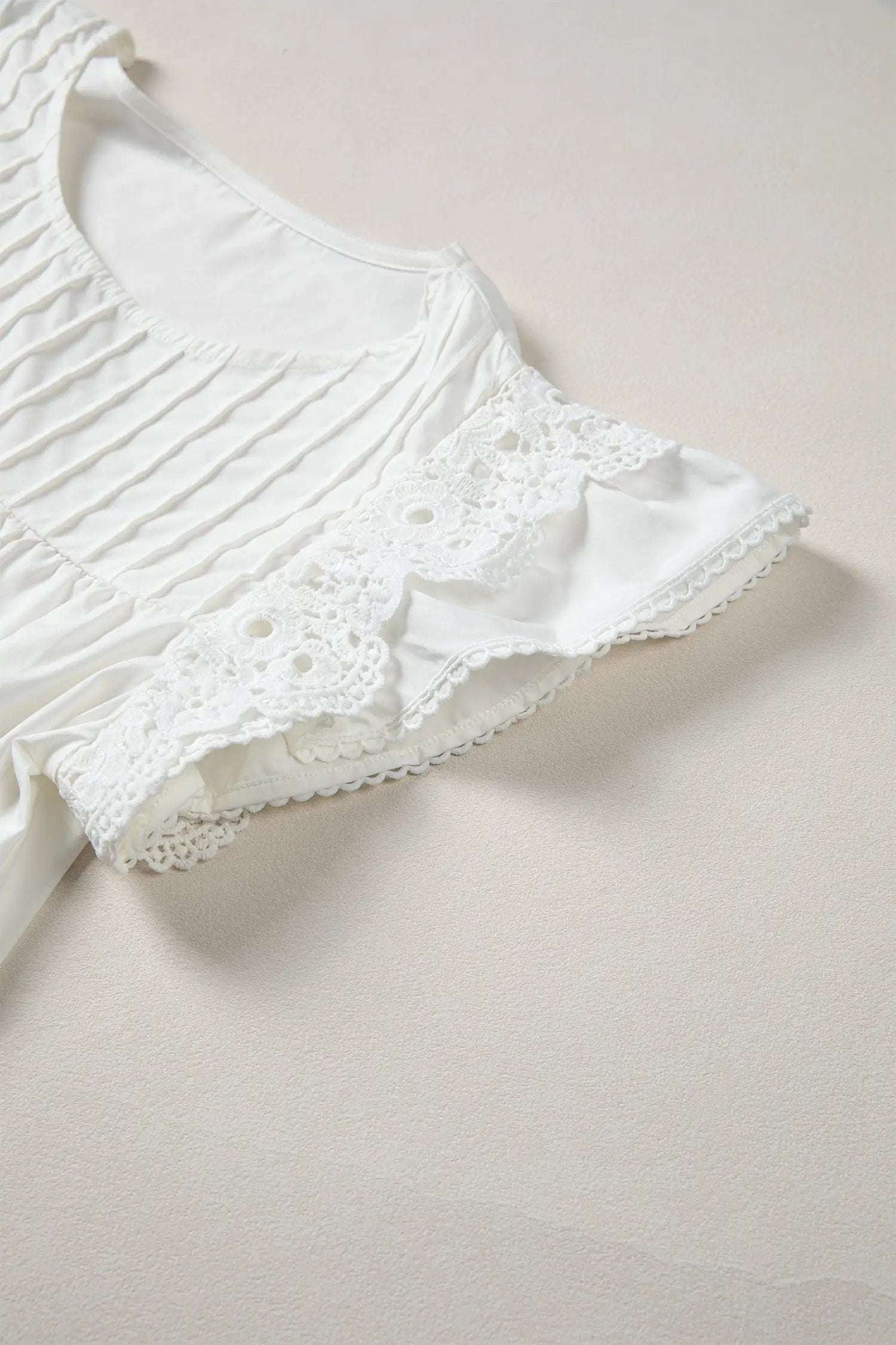 White Southern Charm blouse with lace detail flutter sleeves and pleated round neck