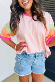 Woman wearing pink color block sleeve oversized top with round neck and relaxed fit