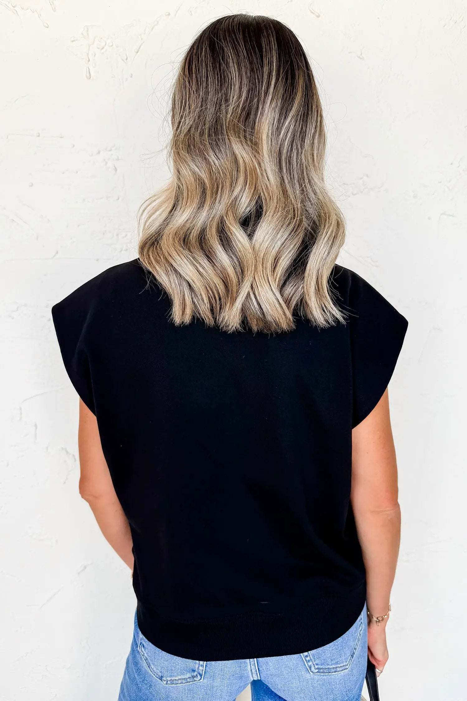 Black short sleeve top with metal buttons for effortless chic mom style