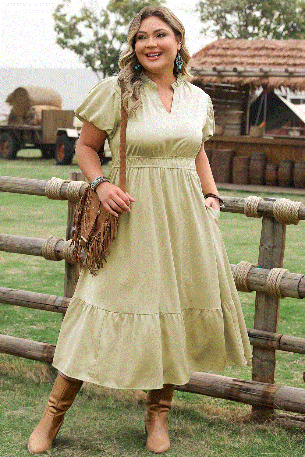 Plus size model wearing notched v-neck puff sleeve tiered maxi dress