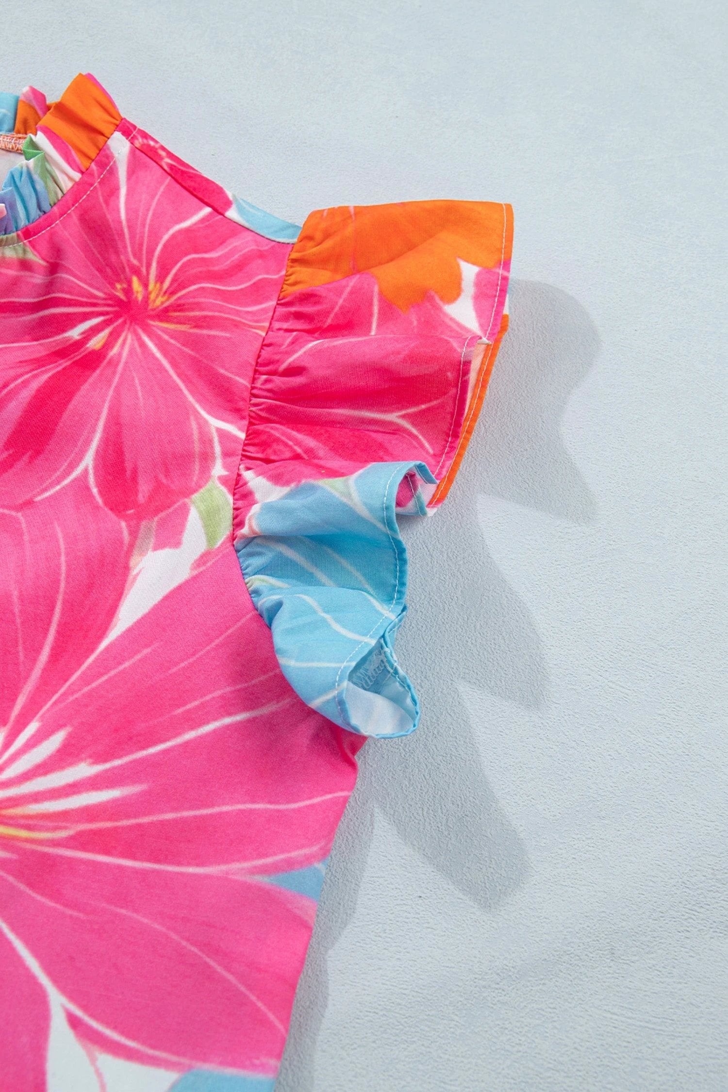 Multicolor vibrant floral tie-neck sleeveless blouse with ruffle trim for vacation vibes